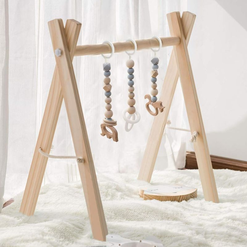 Photo 1 of Wooden Baby Gym with 3 Gym Toys, Foldable Baby Play Gym, Natural Pine Wood Play Gym, Frame Activity Center Hanging Bar Newborn Gift, Newborn Gift for Baby Girl and Boy, Grey