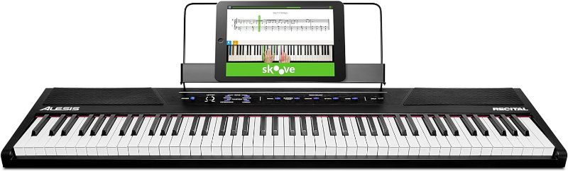 Photo 1 of Alesis Recital – 88 Key Digital Piano Keyboard with Semi Weighted Keys, 2x20W Speakers, 5 Voices, Split, Layer and Lesson Mode, FX and Piano Lessons
