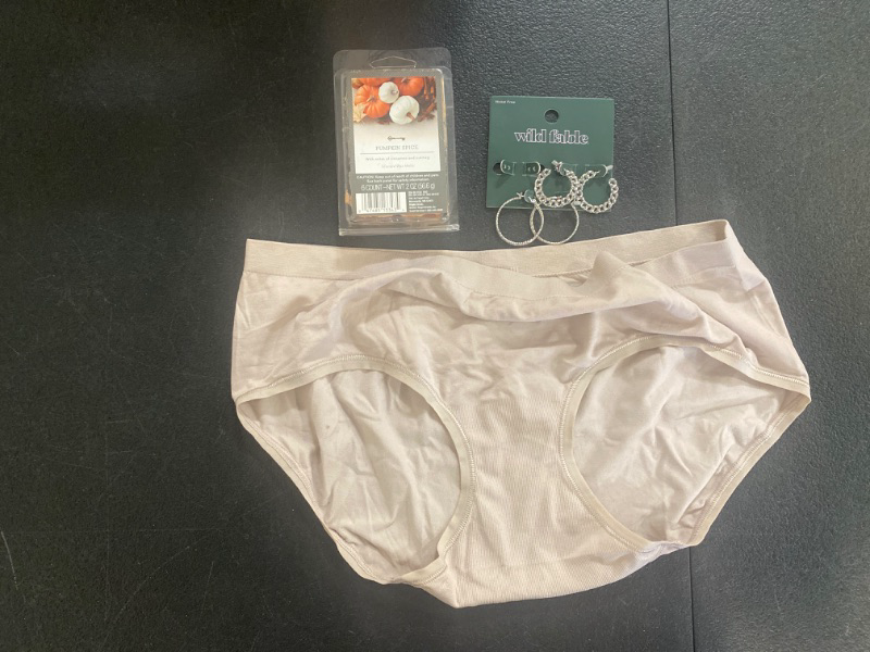 Photo 1 of 4 piece lot- 2 pairs of earing's, 1 pumpkin spice wax, and 1 pair of women's underwear (size 7).