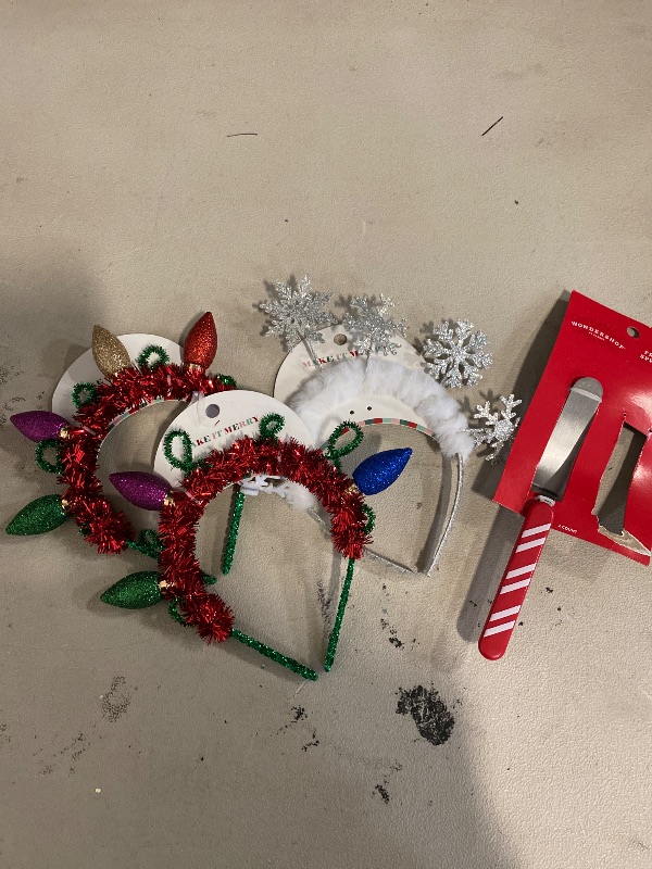 Photo 1 of Christmas themed head bands 2 are damaged 1 still in good condition . 
1 frosting spreader .