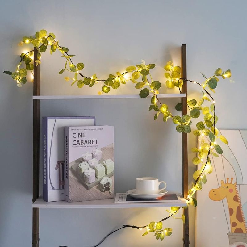 Photo 1 of Lighted 80 LED Eucalyptus Garland Battery Operated 6.2FT Artificial Greenery Twig Vine Lights for Wedding Party Room Christmas Spring Decoration Indoor Outdoor
