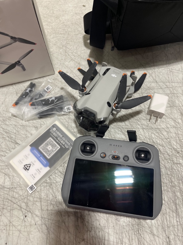 Photo 5 of **DOESN'T CONNECT TO SATELLITE, FOR PARTS ONLY** DJI - Mini 4 Pro Fly More Combo Plus Drone and RC 2 Remote Control with Built-in Screen - Gray - DOESNT CONNECT TO SATELLITE- MISSING POWER CORD - MISSING 1 BATTERY & BATTERY HOLDER ONLY HAS SHOWN IN PICTUR