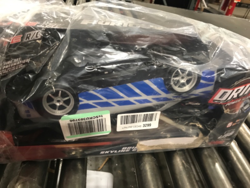 Photo 2 of Jada Toys Fast & Furious Brian's Nissan Skyline GT-R (BN34) Drift Power Slide RC Radio Remote Control Toy Race Car with Extra Tires, 1:10 Scale, Silver/Blue (99701)