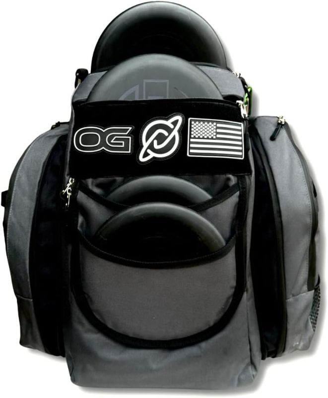Photo 1 of ***NEEDS CLEANING***Discology Disc Golf OG V2 Grey & Black Disc Golf Bag | 26+ Disc Capacity | Premium Disc Golf Backpack Bag | Tough, Durable Design | 2 Large Side Compartments | Two Patches Included - Flag Patch Not Included