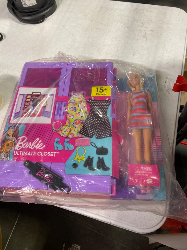 Photo 1 of Barbie Fashionistas Ultimate Closet Portable Fashion Toy with Doll, Clothing, Accessories and Hangers, Gift for 3 Years Old and Up Purple Closet with Doll