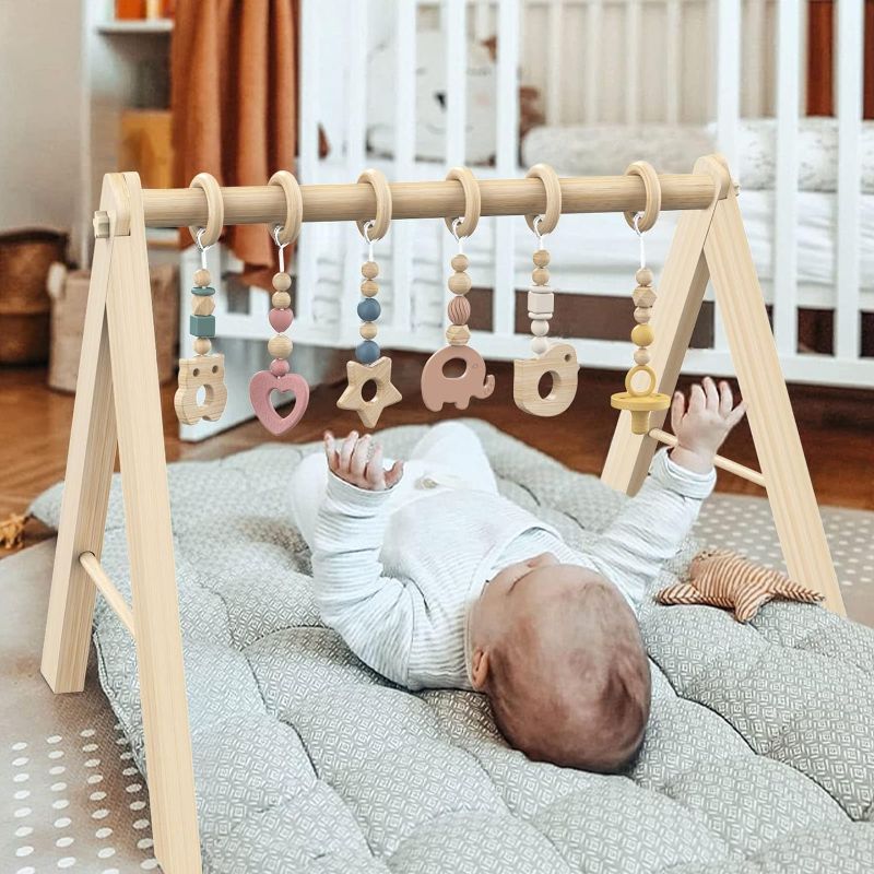 Photo 1 of BESFAN Baby Play Gym with 6 Hanging Toys,Wooden Play Gym Activity Gym with Hanging Baby Toys for Baby Tummy Time Mat Baby Basket Baby Lounger Baby Gifts