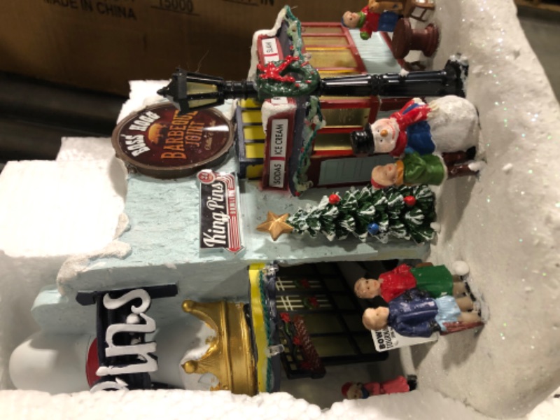 Photo 3 of Moments in Time Christmas Village Building, King Pins Bowling Alley and Boss Hogg Barbeque Joint with LED Lights and Christmas Music - Battery Operated (not Included) (8.4" H x 9.25" W x 8.6" D)