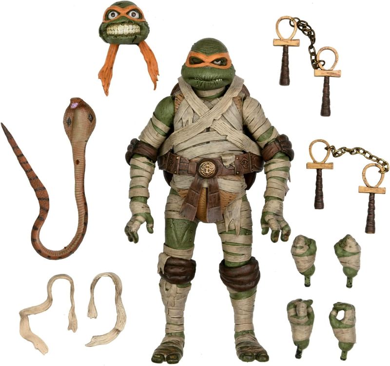 Photo 1 of  NECA Universal Monsters X Teenage Mutant Ninja Turtle 7-Inch Scale Ultimate Michelangelo Mummy Action Figure with Interchangeable Heads and Accessories 