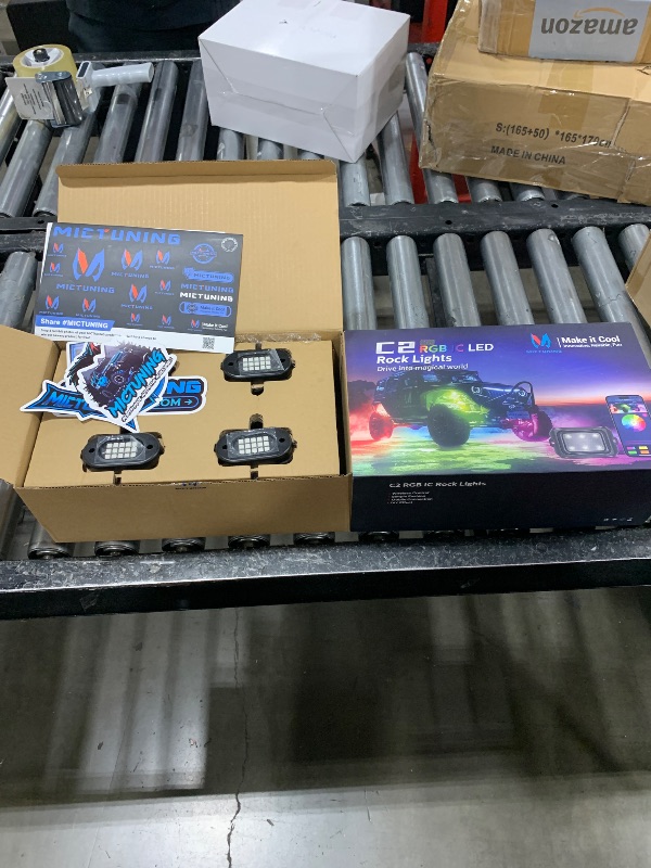 Photo 1 of MICTUNING C2 Max RGB+IC Chasing Color LED Rock Lights - 12 Pods Underglow Lighting Kit, Dynamic Lighting Modes, Extensible Up to 24 Pods with Stable APP Control, IP68 Waterproof, DIY Effect