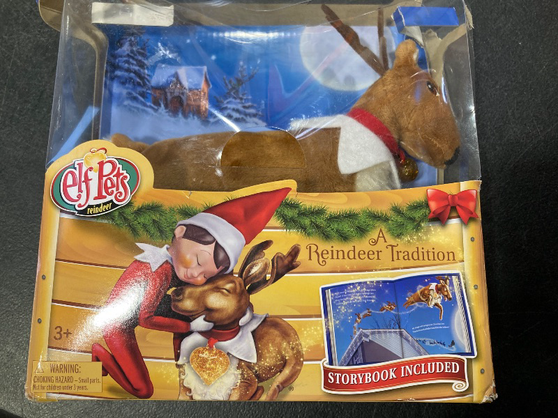 Photo 1 of Elf Pets: A Reindeer Tradition - Includes Beautifully Illustrated Hardbound Storybook, Huggable Elf Pet Reindeer Stuffed Animal with Golden Heart Charm and Official Adoption Certificate