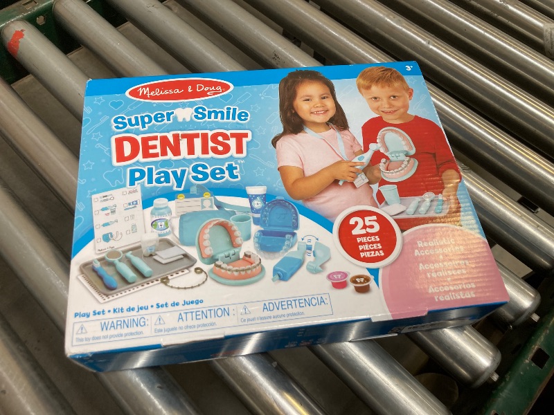 Photo 1 of  Melissa & Doug Super Smile Dentist Kit With Pretend Play Set of Teeth And Dental Accessories (25 Toy Pieces) Pretend Dentist Play Set, For Kids Ages 3+ 