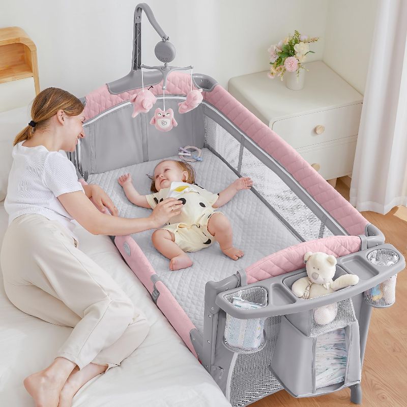 Photo 1 of ADOVEL Baby Bassinet Bedside Crib, Pack and Play with Mattress, Diaper Changer and Playards from Newborn to Toddles, pink