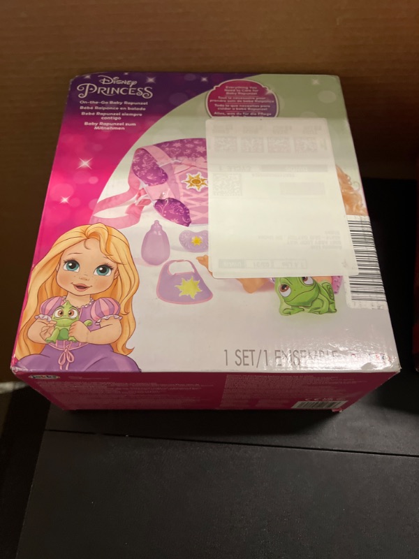 Photo 2 of Disney Princess Rapunzel Baby Doll Deluxe with Tiara, Carrier, Plush Friend, Pacifier, Bib & Baby Bottle [Amazon Exclusive]