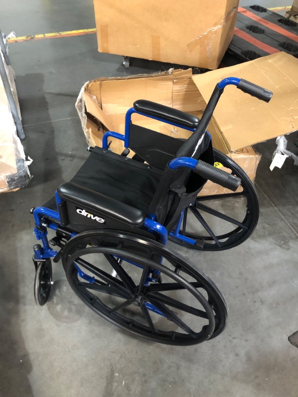 Photo 1 of (Broken wheel) 
Drive Medical Blue Streak Wheelchair with Flip Back Desk Arms, Elevating Leg Rests, 16 Inch Seat