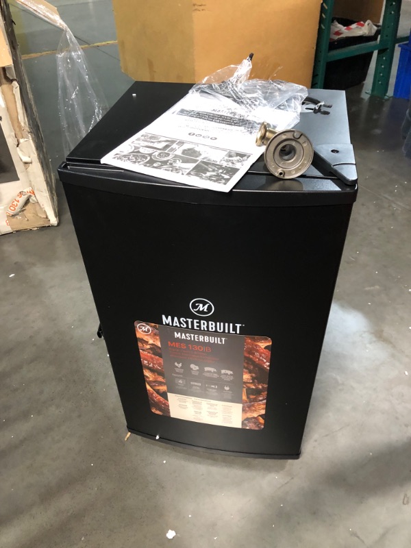 Photo 2 of ***DAMAGED - DENTED - NO PACKAGING - LIKELY MISSING PARTS - UNABLE TO VERIFY FUNCTIONALITY - SEE PICTURES***
Masterbuilt® 30-inch Digital Electric Vertical BBQ Smoker with Side Wood Chip Loader, Chrome Racks and 710 Cooking Square Inches in Black, Model M