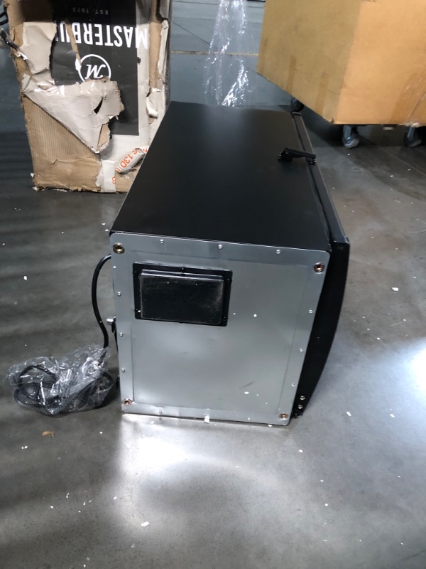 Photo 9 of ***DAMAGED - DENTED - NO PACKAGING - LIKELY MISSING PARTS - UNABLE TO VERIFY FUNCTIONALITY - SEE PICTURES***
Masterbuilt® 30-inch Digital Electric Vertical BBQ Smoker with Side Wood Chip Loader, Chrome Racks and 710 Cooking Square Inches in Black, Model M