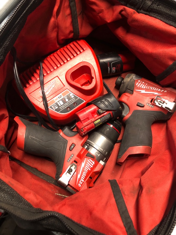 Photo 2 of **DIRTY / HEAVILY USED/ MISSING 1 BATTERY**
Milwaukee Electric Tools 2598-22 M12 Fuel 2 Pc Kit- 1/2" Hammer Drill and 1/4" Impact