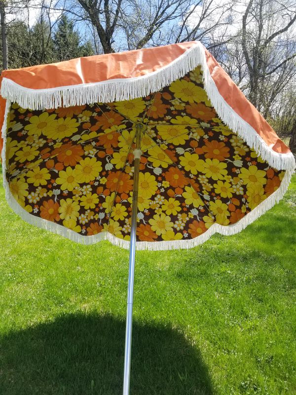 Photo 1 of ***STOCK PHOTO FOR REFERENCE ONLY - ACTUAL ITEM MAY DIFFER - SEE COMMENTS***
Orange Patio Umbrella with White Fringe Border, Flower Pattern Interior, Silver Pole