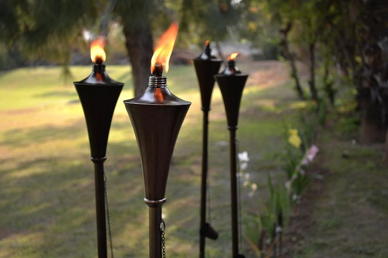 Photo 1 of Deco Window 60" Garden Torch Set of 4 Metal Casted Outdoor Backyard Patio Lighting Citronella Oil Lamp with Snuffer & Fiberglass Wick (Brown)