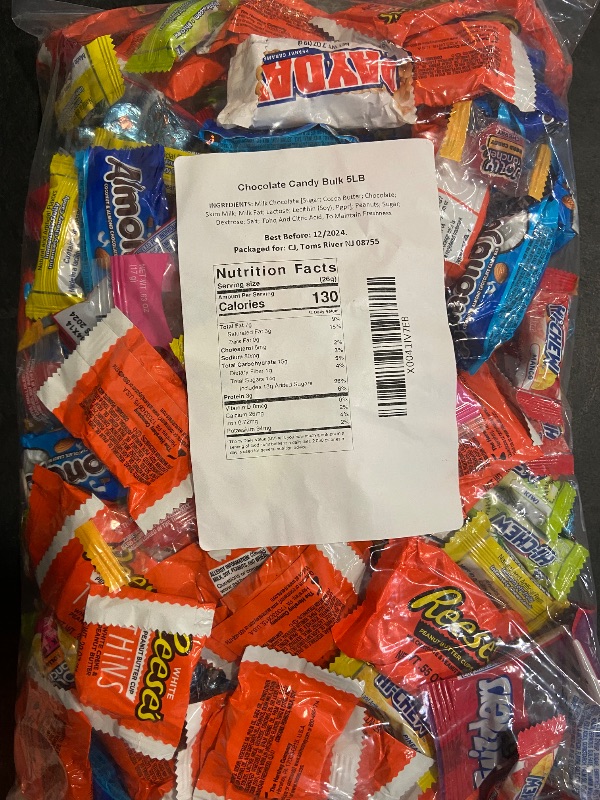 Photo 1 of Assorted candy bag full with heresy's kisses, Reese's thin white chocolate , paydays, twizzles wild berry, almond joys, hi chews, and jolly rancher hards and suckers. Expires 12/2024