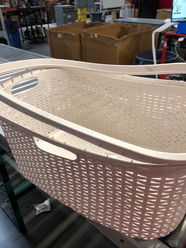 Photo 2 of **minor damge rim does not lock in still functional**
40 Liter Ivory Plastic Laundry Basket with Cutout Handles