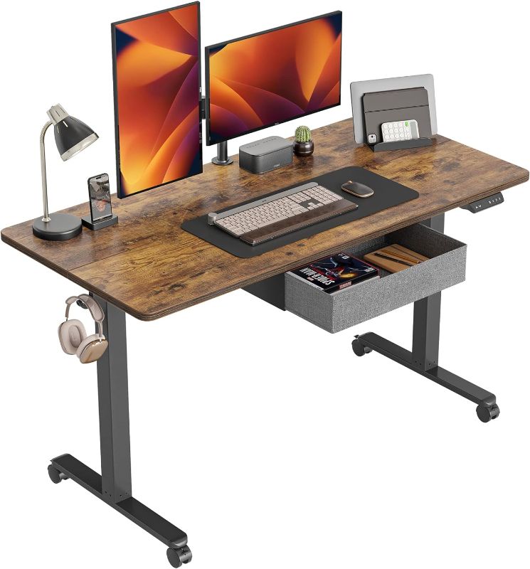 Photo 1 of CubiCubi 63 x 24 Inch Standing Desk with Drawer, Electric Stand up Adjustable Height Electric Stand up Desk, Sit Stand Home Office Desk, Ergonomic Workstation Black Steel Frame/Rustic Brown Tabletop