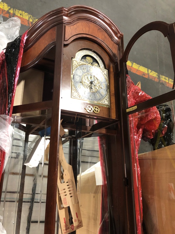 Photo 6 of **GLASS FACE OF CLOCK IS BROKEN. GLASS BROKEN THROUGHOUT. DAMAGED NEAR BOTTOM*SEE NOTES**Howard Miller Liskov Floor Clock II 549-028 – Large Windsor Cherry Curio Cabinet with Cable-Drive, Triple-Chime Movement with Volume Control
