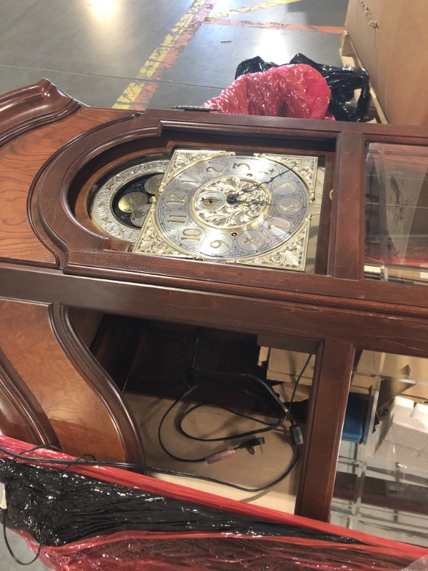 Photo 9 of **GLASS FACE OF CLOCK IS BROKEN. GLASS BROKEN THROUGHOUT. DAMAGED NEAR BOTTOM*SEE NOTES**Howard Miller Liskov Floor Clock II 549-028 – Large Windsor Cherry Curio Cabinet with Cable-Drive, Triple-Chime Movement with Volume Control
