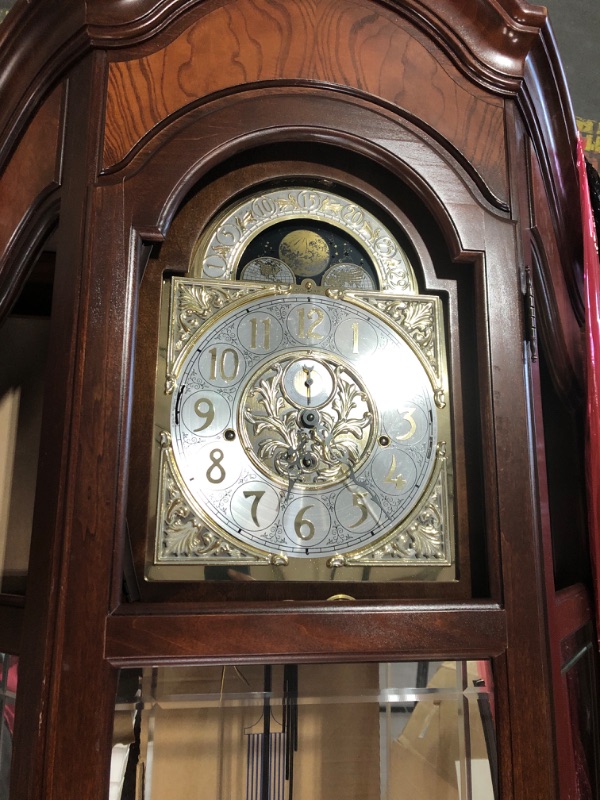 Photo 8 of **GLASS FACE OF CLOCK IS BROKEN. GLASS BROKEN THROUGHOUT. DAMAGED NEAR BOTTOM*SEE NOTES**Howard Miller Liskov Floor Clock II 549-028 – Large Windsor Cherry Curio Cabinet with Cable-Drive, Triple-Chime Movement with Volume Control
