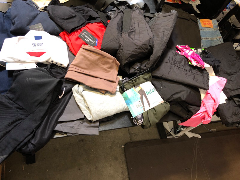 Photo 6 of clothing box lot clothing is new but stained sizing colors and style vary per item no returns or exchanges sports bra pink leggings nike etc ;  LEVIS