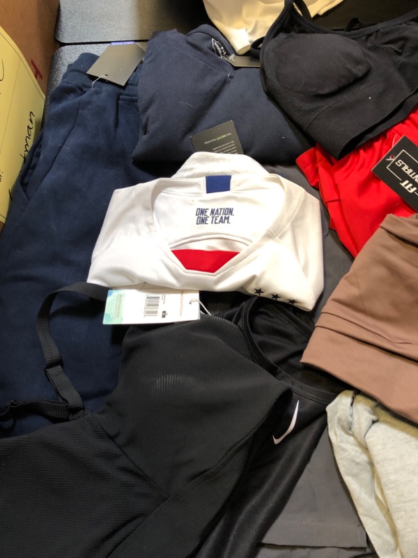 Photo 2 of clothing box lot clothing is new but stained sizing colors and style vary per item no returns or exchanges sports bra pink leggings nike etc ;  LEVIS