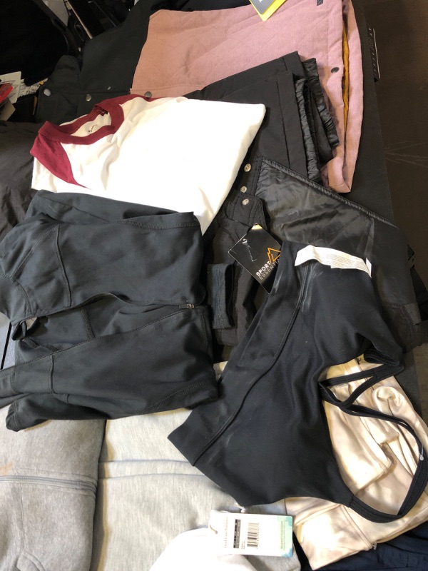 Photo 2 of clothing bAG lot clothing is new/ USED  but stained sizing colors and style vary per item no returns or exchanges sports bra SWEATS STAINS ON ZIP UP BLACK BBL JACKET XL BASEBALL TEES 