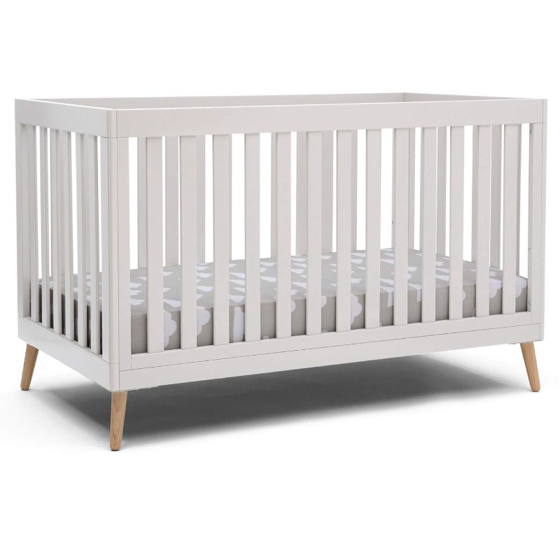 Photo 1 of Delta Children Essex 4-in-1 Convertible Baby Crib, Bianca White with Natural Legs + Simmons Kids Quiet Nights Dual Sided Crib and Toddler Mattress (Bundle)