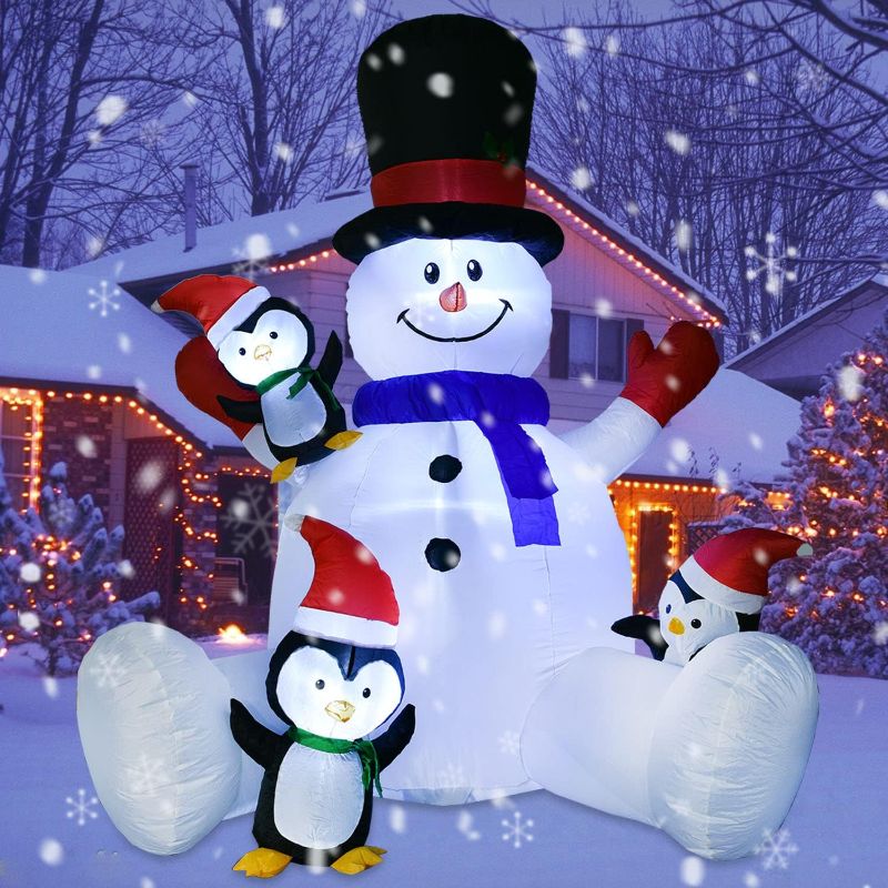 Photo 1 of DearHouse 7Ft Lighted Christmas Inflatable Snowman with Three Cute Penguins, Building 3 LED Lights Outdoor Indoor Holiday Decorations Blow up Yard Inflatables Home Decor
