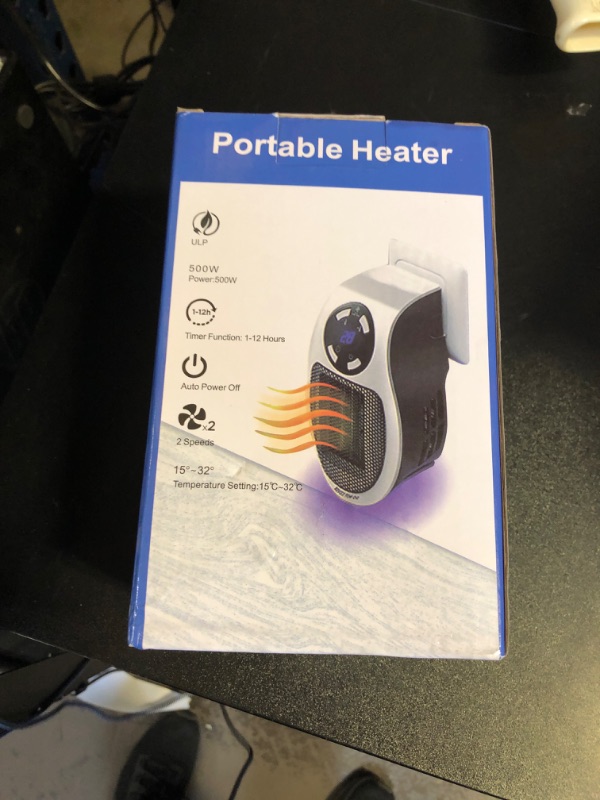 Photo 1 of Plug -in White Mini Portable Heater with 2 Speeds.
