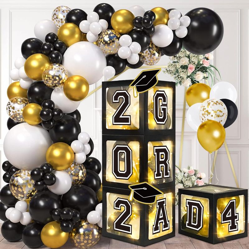 Photo 1 of  DAZONGE 2024 Graduation Decorations Black and Gold - Set of 4 Grad Boxes with 139pcs Balloon Arch Garland Kit & 4 Light Strings - So Proud of You 2024 Graduation Party Decorations for Any