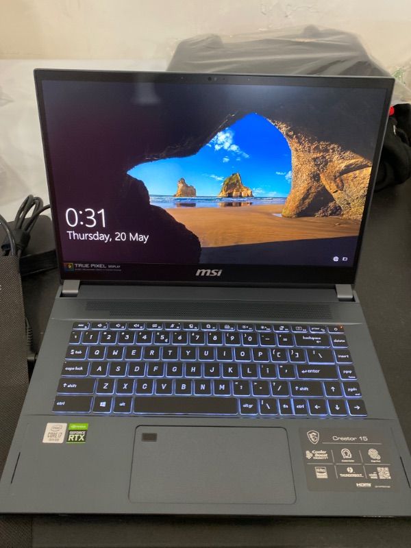 Photo 2 of MSI CREATOR 15 A10SFS-287 15.6" UHD 4K ULTRA THIN BEZEL ADOBE 100% THIN AND LIGHT PROFESSIONAL LAPTOP INTEL CORE I7-10875H GEFORCE RTX 2070 SUPER 32GB SCREEN DOES NOT TURN ON, BATTERY DOES NOT HOLD CHARGE, LAPTOP TURNS OFF SHORTLY AFTER TURNING ON WITH NO