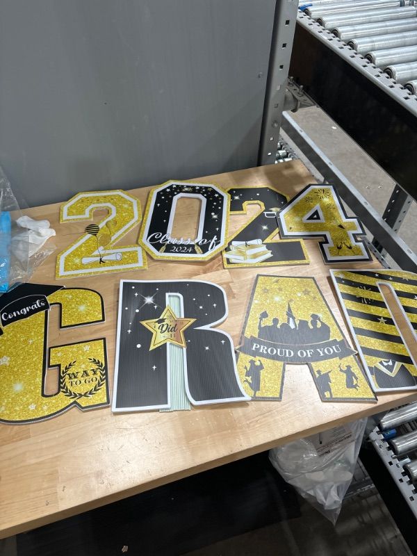 Photo 1 of Graduation Yard Signs Decorations Class Of 2024 15 Inch Graduation Yard Sign 11 PCS Black Gold Congrats Grad Lawn Signs with 22 Stakes High School College Graduation Party Decoration Outdoor