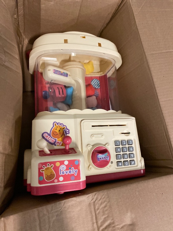 Photo 1 of 25PCS 2 in 1 Large Claw Machine and ATM Piggy Bank, with Music & Light, Party Birthday for 3-14 Kids Gift, for Real Money Savings and Grabber Prize Dispenser Toys, Pink