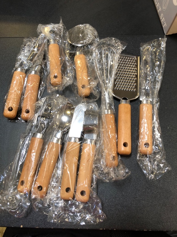 Photo 1 of 
KITCHEN GADGET SET 9 PIECE INCLUDES CAN OPENER/ICE CREAM SCOOP/ PEELER/ PIZZA CUTTER / GARLIC PRESS/ CHEESE GRATER / WHISK/ CHEESE KNIFE/ BOTTLE  OPENER WOOD HANDLES