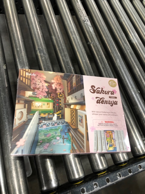 Photo 1 of ROBOTIME DIY Book Nook Kit Decorative Bookend Insert Bookcase Book Stand Miniature House Kit with LED Light Creative Gift for Birthdays (Sakura Tram)