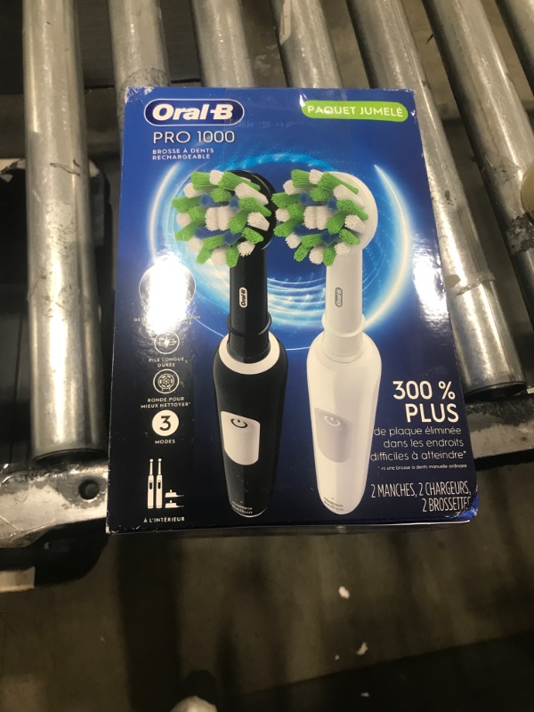 Photo 2 of Oral-B Pro 1000 CrossAction Electric Toothbrush, Black and White, 2 Count Black & White 2 Count (Pack of 1)