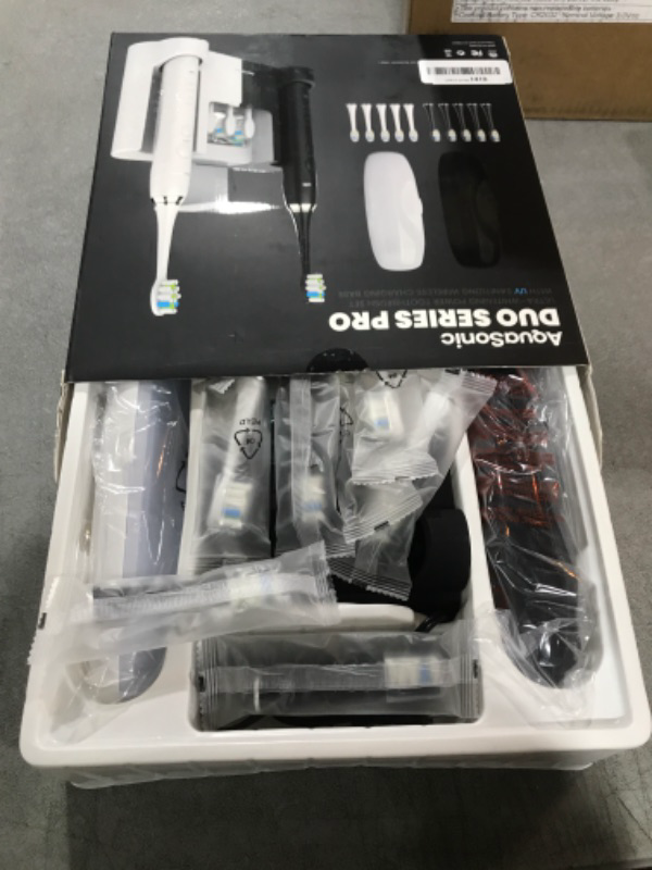 Photo 2 of AquaSonic DUO PRO – Ultra Whitening 40,000 VPM Electric ToothBrushes – ADA Accepted - 4 Modes with Smart Timers - UV Sanitizing & Wireless Charging Base - 10 ProFlex Brush Heads & 2 Travel Cases