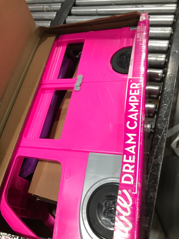 Photo 1 of Barbie Camper Playset, DreamCamper Toy Vehicle with 60 Doll-Sized Accessories Including Furniture, Pool & 30-inch Slide
