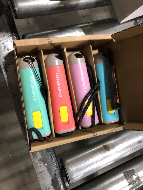 Photo 1 of EverBrite 4-Pack Mini LED Plastic Flashlight, Kids Party Favors Torch Colors Assorted for Children Projector, Hurricane Supplies with Lanyard 3AAA Battery Included