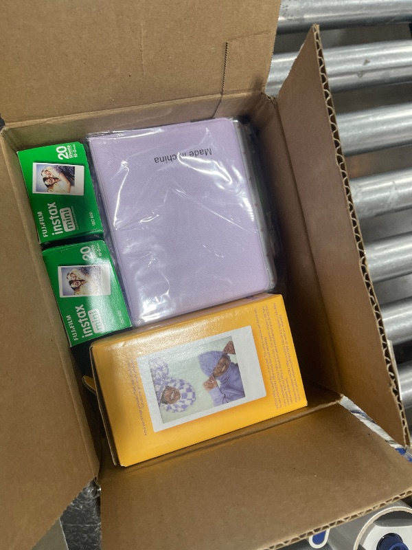 Photo 1 of Fujifilm Instax Mini 12 Instant Camera with Fujifilm Instant Mini Film (50 Sheets) with Accessories Including Compatible Case with Strap, Lenss Photo Album, Stickers, Frames Bundle (Lilac Purple)