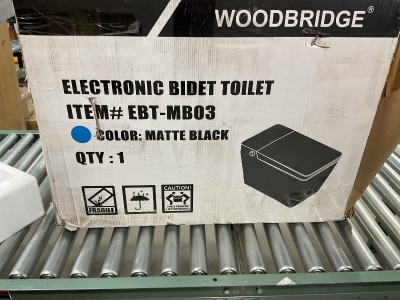 Photo 1 of *FOR PARTS ONLY* WOODBRIDGE Square Smart Bidet Toilet with Auto Open & Close, Foot Sensor, Auto Flush, Multiple Spray Modes, Heated Seat, Warm Water and Air Dryer, Auto LED Nightlight, Matte Black, EBT-MB03 It appears the side of me have been used once or