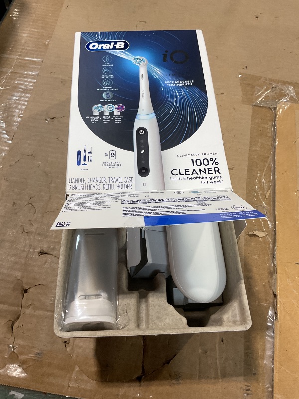 Photo 1 of **MISSING PARTS** Oral-B Rechargeable Electric Toothbrush, iO5 Limited Deep Clean & Whiten, 5 Cleaning Modes, Visual Pressure Sensor to Protect Gums, Travel Case, 3 Brush Heads, White