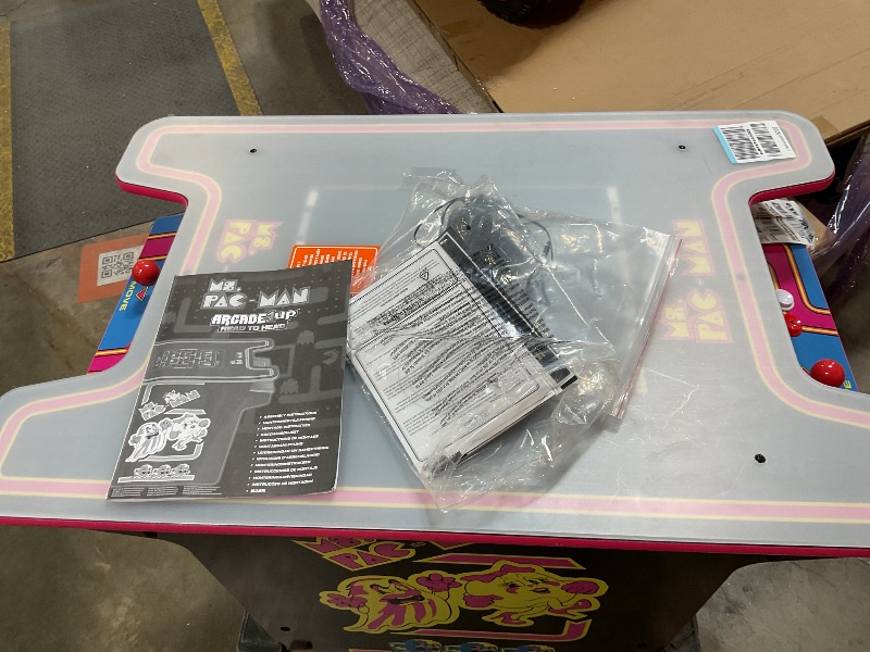 Photo 1 of ***UNTESTED AND PARTS MAYBE NEEDED FOR INSIDE*** Arcade1Up Ms.PAC-Man Head-to-Head Arcade Machine – Retro Home Arcade Table with 12 Classic Games, Light-Up Control Deck & Real-Feel Joysticks