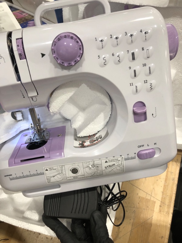 Photo 2 of **POWERS ON, FOOT PEDAL FUNCTIONAL, MISSING  ACCESSORIES**
JUCVNB Mini Sewing Machine for Beginners and Kids Ages 8-12, Portable Sewing Machines with 12 Built-in Stitch Patterns, Light, 2 Speed Foot Pedal - Purple & White (with Basic Accessory Kit)